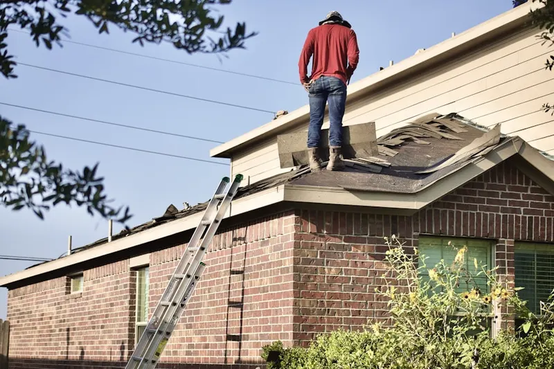 Professional roofer working on a residential roof in Sweet Water